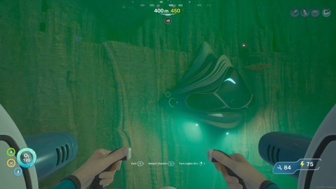 The player in Subnautica 2 pilots their Tadpole towards the Lower Control Room, an Axum alien building constructed into the side of the cliff face by the Karakorum Power Plant.